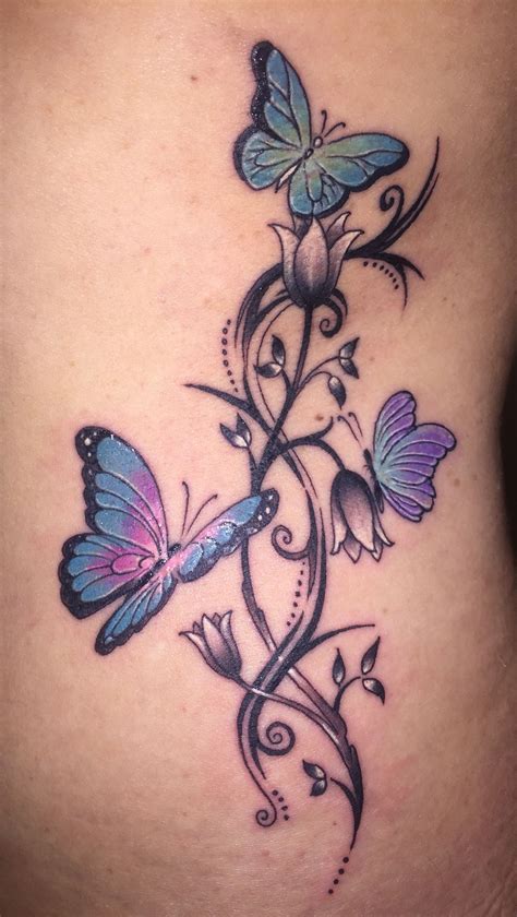 butterfly tattoo with flowers around it